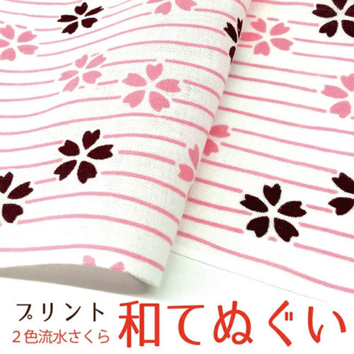 A traditional Japanese Tenugui towel featuring a delicate sakura pattern in two colors, made from breathable cotton fabric. Crafted in Japan, perfect for versatile everyday use. Available at j-okini.com