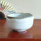 Mino ware Matcha bowl with a white glaze that enhances the green of Matcha, a winding dark green-brown rim, and a wabi-sabi aesthetic, handcrafted in Japan Available at j-okini.com in Malta