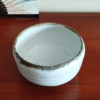 Mino ware Matcha bowl with a white glaze that enhances the green of Matcha, a winding dark green-brown rim, and a wabi-sabi aesthetic, handcrafted in Japan Available at j-okini.com in Malta