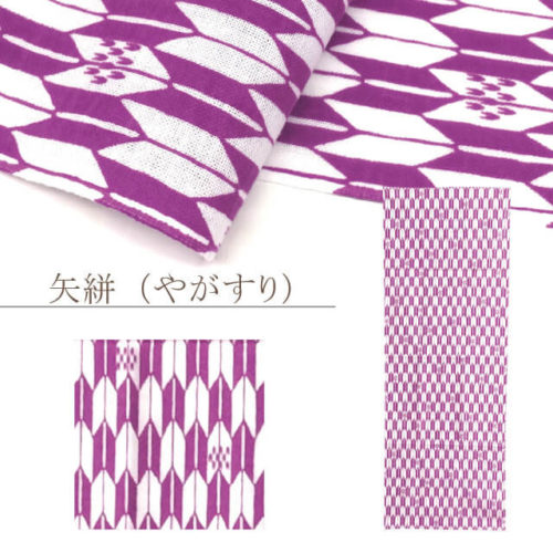 A traditional Japanese Tenugui towel with Komon' (小紋) pattern with featuring a striking 矢絣 (Yagasuri) pattern in elegant purple. Inspired by the fletching of arrows, this traditional motif symbolizes determination and good fortune, made from breathable cotton. Crafted in Japan for versatile everyday use. Shown in close-up, flat, and wrapped around a tissue box. Available at j-okini.com in Malta