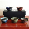 A set of five uniquely glazed Japanese sake cups, each with a different color and finish. Perfect for entertaining or gifting. Made in Japan. Available at j-okini.com in Malta