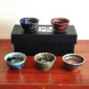 A set of five uniquely glazed Japanese sake cups, each with a different color and finish. Perfect for entertaining or gifting. Made in Japan. Available at j-okini.com in Malta