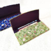 A Hana Chirimen Kimono Wallet with a bunny and sakura pattern, featuring a fold-over design. Made from Kyoto's traditional Chirimen fabric. Available in green or blue. Available at j-okini.com in Malta