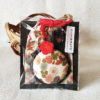 A Japanese-style portable hand mirror with a matching drawstring pouch, featuring traditional patterns and a decorative charm. Available at j-okini.com in malta