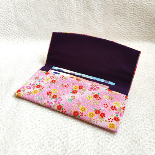 Fold-over chirimen wallet with sakura motifs in pink—lightweight, stylish, and made in Japan. Available at j-okini.com in Malta