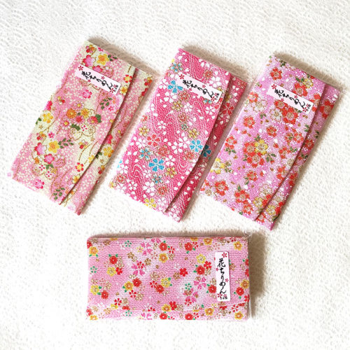 Elegant Japanese kimono wallet with a soft chirimen texture, featuring a unique pink sakura design. Available at j-okini.com in Malta